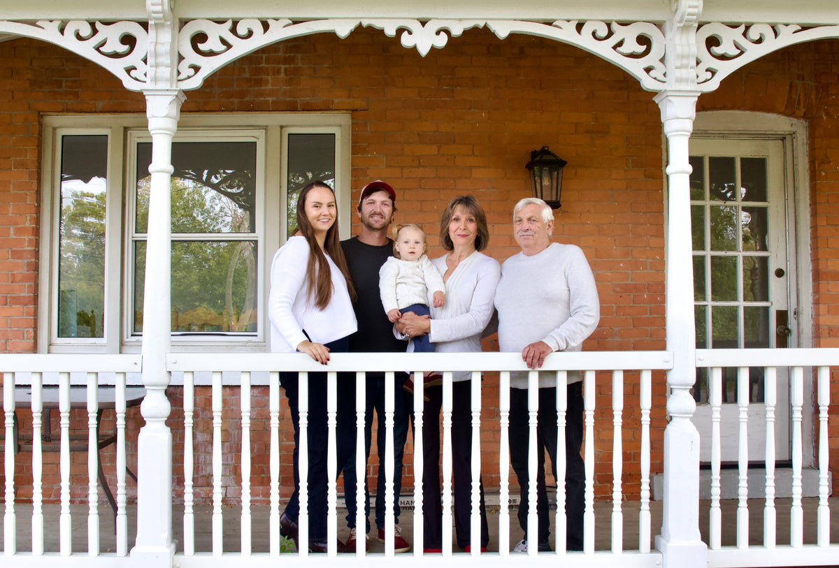 The Jenkins Family, posing for a picture on the front porch of the red brick house. From  left to right; Kaylee, Quinton, Indigo, Ruth, and Gord.